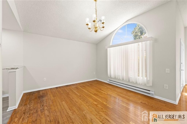 unfurnished room featuring lofted ceiling, a textured ceiling, a chandelier, baseboard heating, and hardwood / wood-style floors