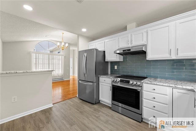 kitchen featuring under cabinet range hood, white cabinets, vaulted ceiling, appliances with stainless steel finishes, and light wood-type flooring