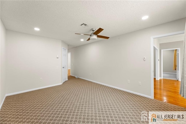 unfurnished room with baseboards, carpet floors, visible vents, and recessed lighting