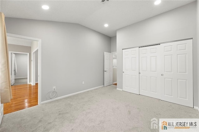 unfurnished bedroom with recessed lighting, baseboards, vaulted ceiling, and carpet