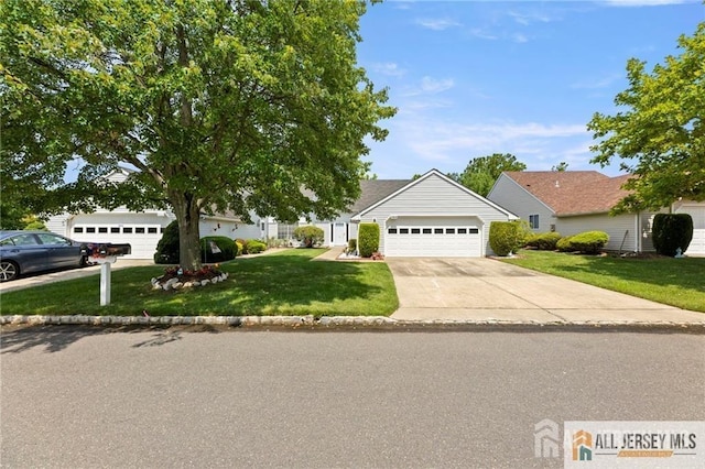 view of front of house with an attached garage, concrete driveway, and a front yard