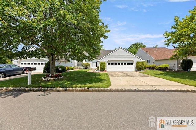 view of front of home with an attached garage, a front yard, and concrete driveway