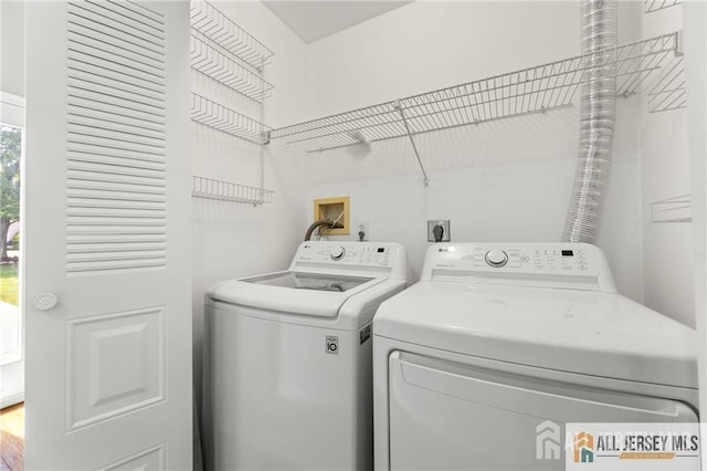 clothes washing area with washer and dryer and laundry area
