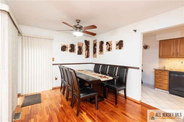 dining area with ceiling fan and light wood-type flooring