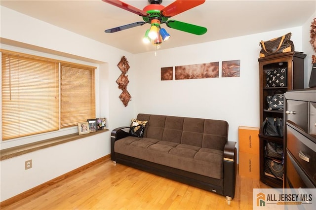 living room featuring hardwood / wood-style floors and ceiling fan