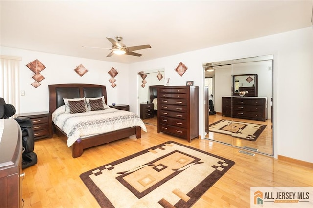 bedroom with ceiling fan, wood-type flooring, and a closet