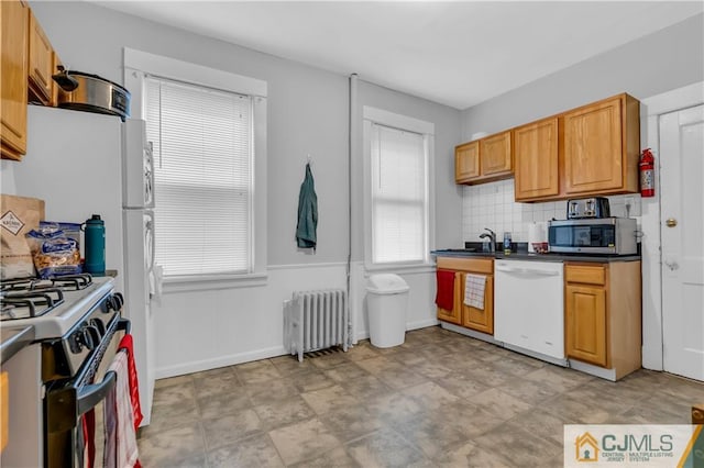 kitchen featuring light tile flooring, radiator heating unit, range with gas stovetop, backsplash, and dishwasher