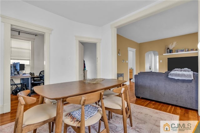 dining space with dark hardwood / wood-style flooring