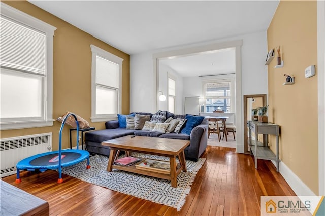 living room featuring dark hardwood / wood-style flooring and radiator heating unit