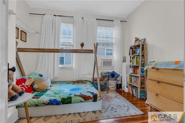 bedroom with dark wood-type flooring, vaulted ceiling, and multiple windows