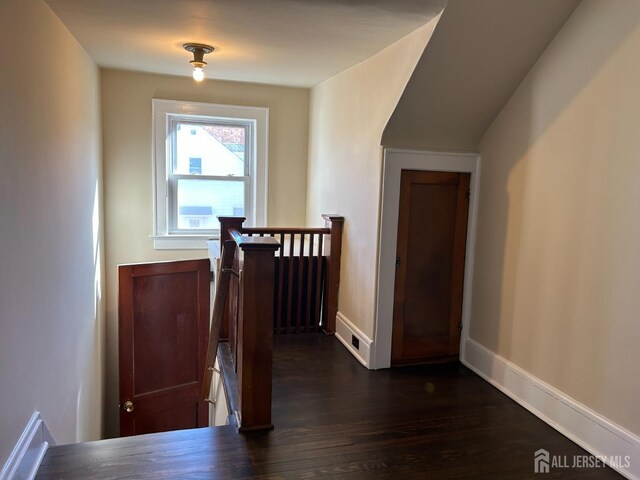 hallway featuring dark hardwood / wood-style flooring