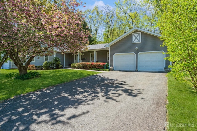 28 Thrush Dr, East Brunswick, NJ 08816 - view of front of house with a garage, driveway, and a front yard