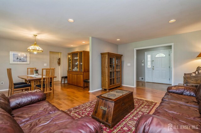 28 Thrush Dr, East Brunswick, NJ 08816 - living area with wood finished floors, recessed lighting, a chandelier, and baseboards