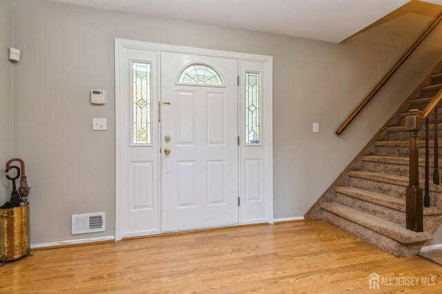 28 Thrush Dr, East Brunswick, NJ 08816 - foyer featuring light wood-style floors, stairway, and baseboards