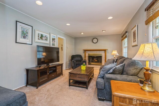 28 Thrush Dr, East Brunswick, NJ 08816 - living area featuring plenty of natural light, carpet floors, a tile fireplace, crown molding, and recessed lighting