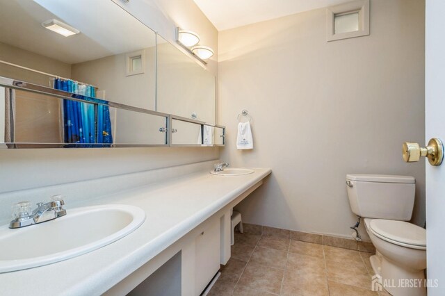 28 Thrush Dr, East Brunswick, NJ 08816 - bathroom with toilet, double vanity, baseboards, tile patterned flooring, and a shower with curtain