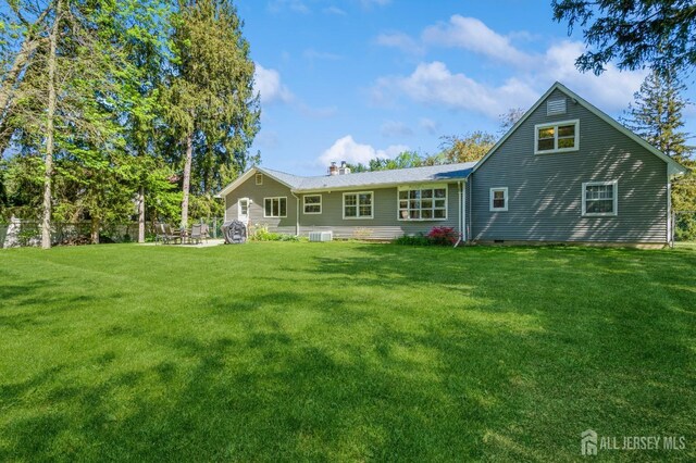 28 Thrush Dr, East Brunswick, NJ 08816 - back of property with a yard, a chimney, and central AC unit