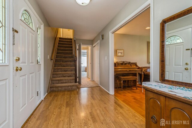 28 Thrush Dr, East Brunswick, NJ 08816 - entryway featuring light wood-style floors, stairway, and baseboards