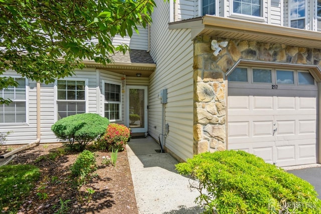 217 Nebula Rd, Piscataway, NJ 08854 - entrance to property with stone siding and an attached garage
