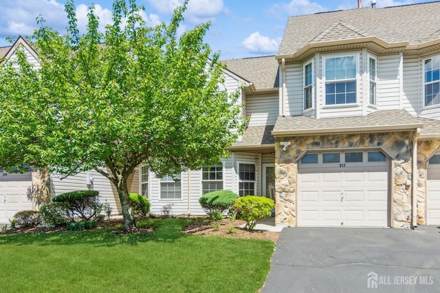 217 Nebula Rd, Piscataway, NJ 08854 - multi unit property featuring an attached garage, a front lawn, a shingled roof, and stone siding