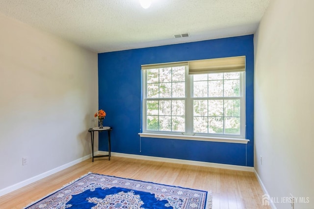 217 Nebula Rd, Piscataway, NJ 08854 - empty room featuring wood finished floors, a textured ceiling, and baseboards