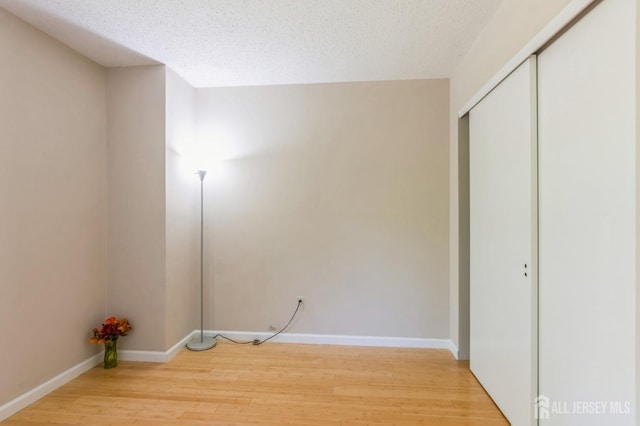 217 Nebula Rd, Piscataway, NJ 08854 - washroom featuring light wood-type flooring, a textured ceiling, and baseboards