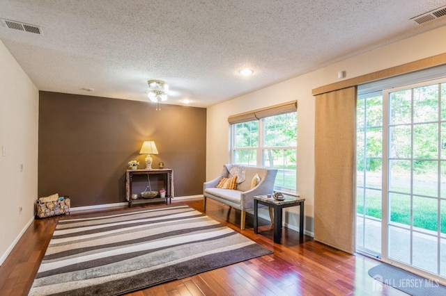 217 Nebula Rd, Piscataway, NJ 08854 - living area featuring a textured ceiling, hardwood / wood-style floors, baseboards, and a ceiling fan