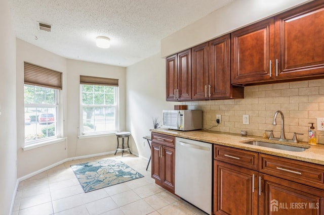 217 Nebula Rd, Piscataway, NJ 08854 - kitchen with dishwasher, white microwave, a sink, decorative backsplash, and light stone counters