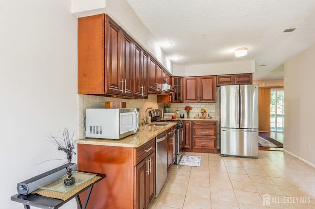 217 Nebula Rd, Piscataway, NJ 08854 - kitchen featuring appliances with stainless steel finishes, tasteful backsplash, a sink, light tile patterned floors, and glass insert cabinets