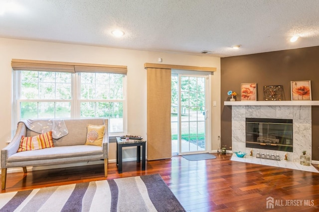 217 Nebula Rd, Piscataway, NJ 08854 - living room with a textured ceiling, wood finished floors, baseboards, a fireplace, and recessed lighting