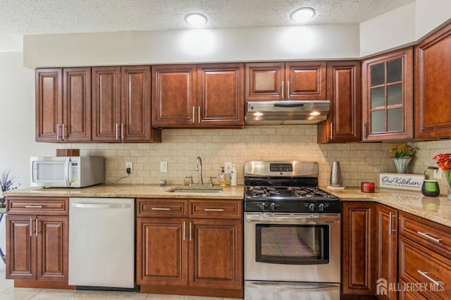 217 Nebula Rd, Piscataway, NJ 08854 - kitchen featuring stainless steel appliances, under cabinet range hood, a sink, a textured ceiling, and light stone countertops