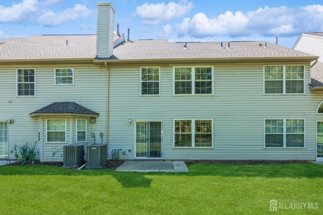 217 Nebula Rd, Piscataway, NJ 08854 - rear view of property featuring a yard, central AC unit, a chimney, and a shingled roof
