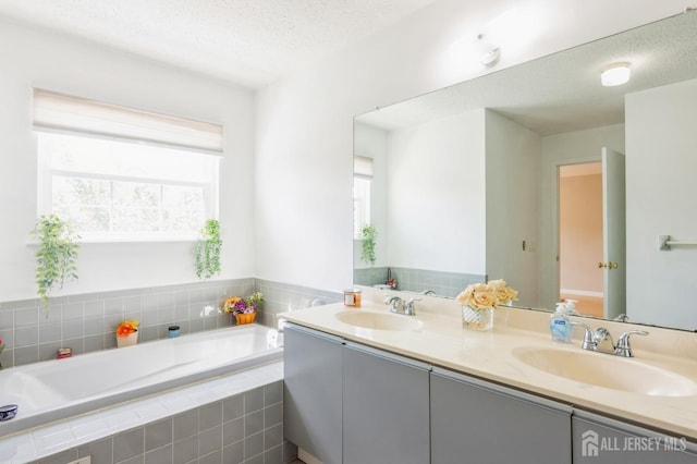217 Nebula Rd, Piscataway, NJ 08854 - full bathroom featuring a bath, double vanity, and a textured ceiling
