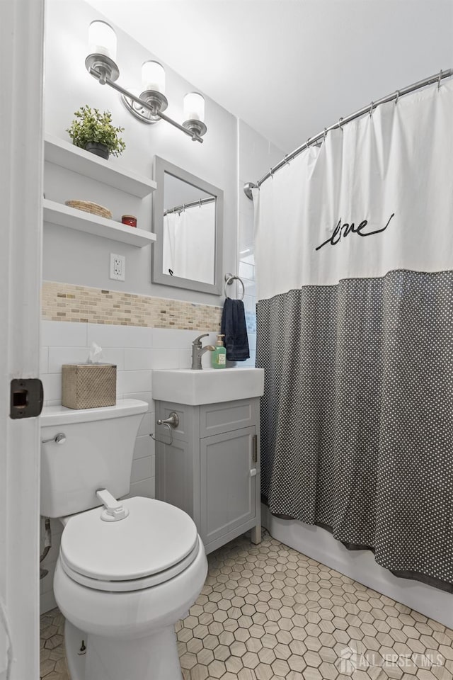 243 Donald Ave, Rahway, NJ 07065 - bathroom with vanity, shower / tub combo with curtain, toilet, tile walls, and wainscoting