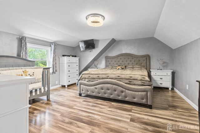 243 Donald Ave, Rahway, NJ 07065 - bedroom with lofted ceiling, wood finished floors, and baseboards