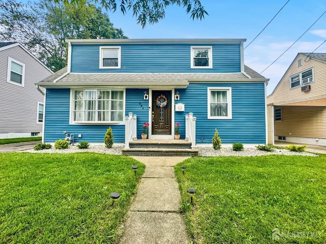 243 Donald Ave, Rahway, NJ 07065 - traditional home featuring a front lawn, cooling unit, and a shingled roof