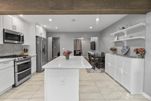 243 Donald Ave, Rahway, NJ 07065 - kitchen featuring stainless steel appliances, a kitchen island, recessed lighting, light countertops, and white cabinets