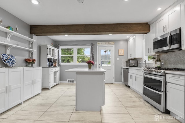 243 Donald Ave, Rahway, NJ 07065 - kitchen with appliances with stainless steel finishes, a center island, decorative backsplash, light countertops, and recessed lighting