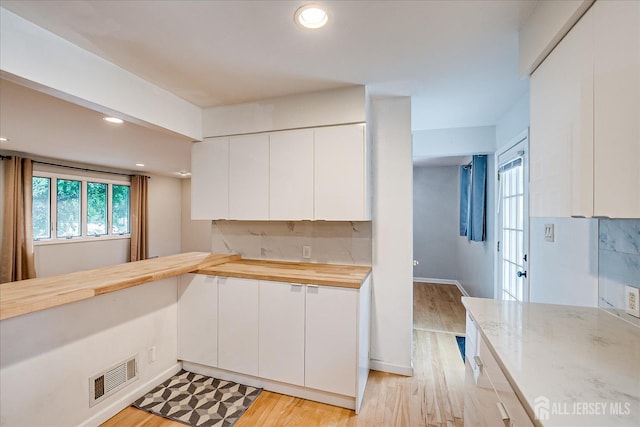 74 Hazelwood Ave, Metuchen, NJ 08840 - kitchen featuring recessed lighting, white cabinets, wood counters, light wood-style floors, and decorative backsplash