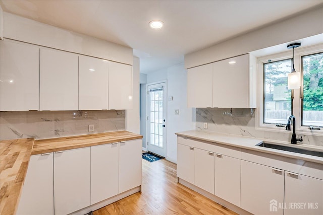 74 Hazelwood Ave, Metuchen, NJ 08840 - kitchen with wooden counters, backsplash, white cabinetry, and recessed lighting