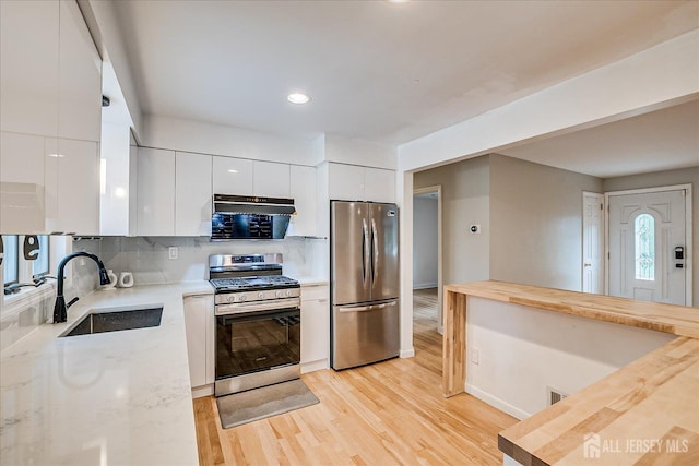 74 Hazelwood Ave, Metuchen, NJ 08840 - kitchen featuring stainless steel appliances, modern cabinets, under cabinet range hood, white cabinets, and recessed lighting