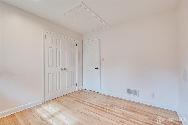 74 Hazelwood Ave, Metuchen, NJ 08840 - unfurnished bedroom featuring attic access, wood finished floors, and a closet