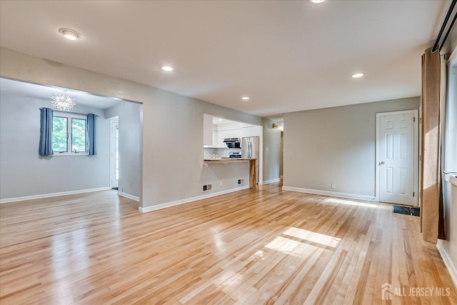 74 Hazelwood Ave, Metuchen, NJ 08840 - unfurnished room with light wood-style floors, recessed lighting, and a chandelier