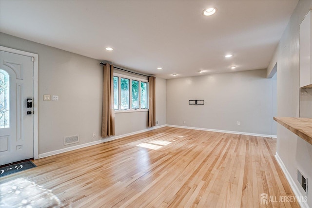 74 Hazelwood Ave, Metuchen, NJ 08840 - unfurnished living room with light wood-style floors and recessed lighting