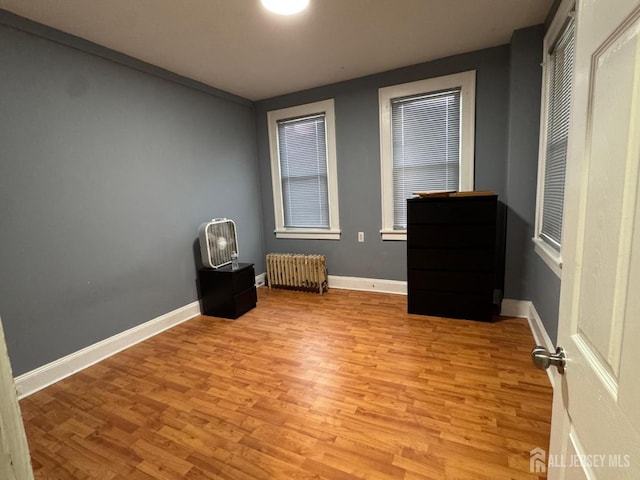 86 Harvey St, New Brunswick, NJ 08901 - unfurnished bedroom with radiator heating unit and light wood-type flooring