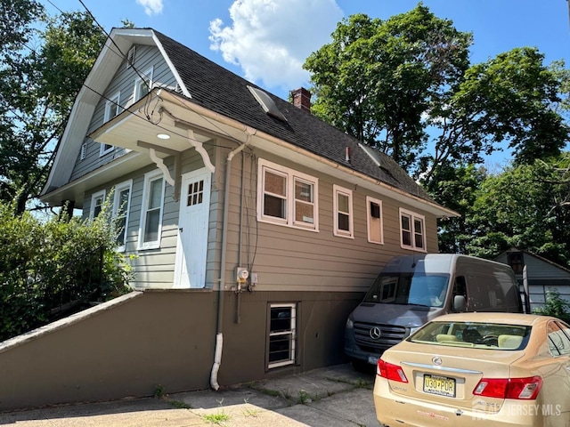 86 Harvey St, New Brunswick, NJ 08901 - view of side of property with roof with shingles and a chimney