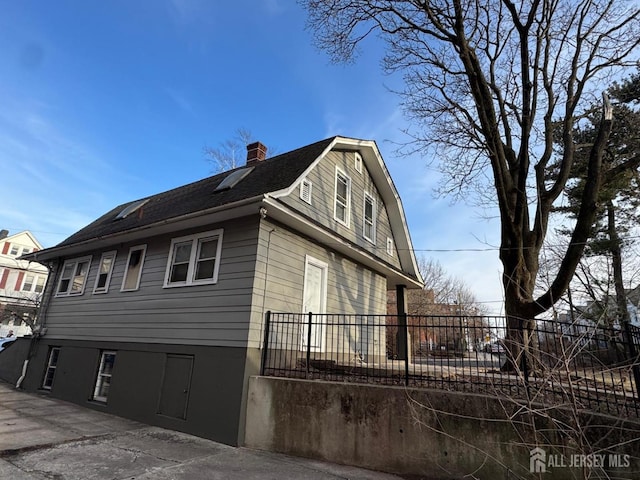 86 Harvey St, New Brunswick, NJ 08901 - view of property exterior featuring a gambrel roof, a chimney, and a shingled roof