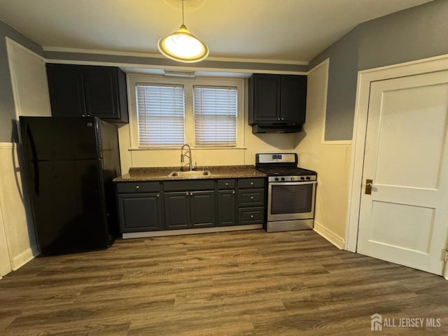86 Harvey St, New Brunswick, NJ 08901 - kitchen featuring stainless steel gas stove, freestanding refrigerator, under cabinet range hood, and dark wood-style floors