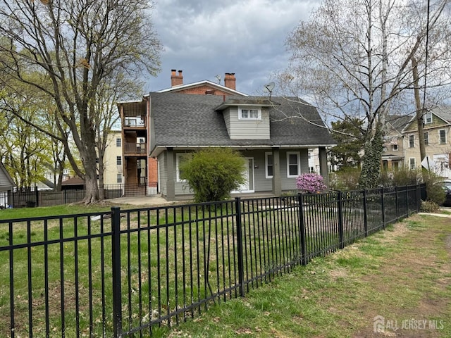86 Harvey St, New Brunswick, NJ 08901 - view of front of property with a fenced front yard, a shingled roof, and a chimney