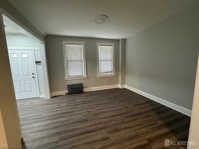86 Harvey St, New Brunswick, NJ 08901 - spare room with radiator and dark wood-style floors